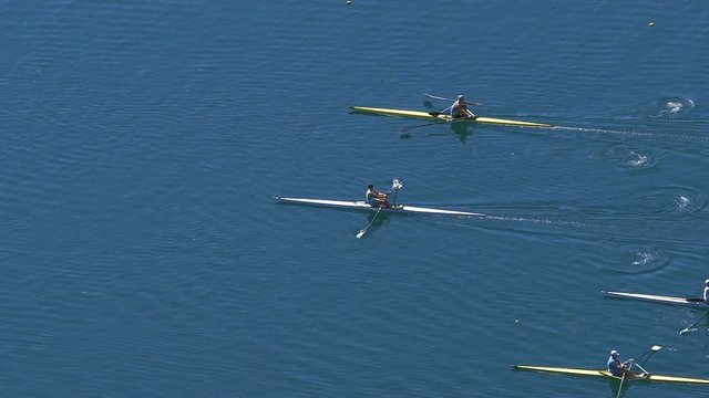 Athlete rowers participating in speed scull race, water sports competition