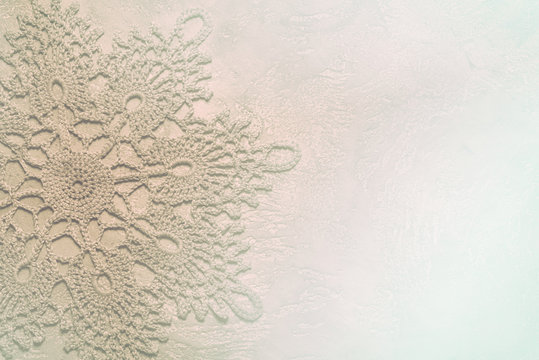 doily crochet tinted in subtle contours in neutral light beige colors, suitable for using as a background for a presentation or background on the theme of needlework, or as a wedding invitation card