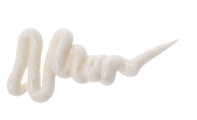 Beige color scrub cream with orange pigment stroke on background