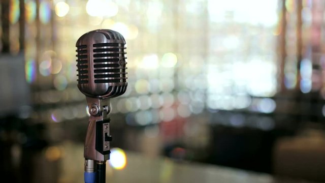 Vintage microphone against a bright background. Microphone. Slow motion.