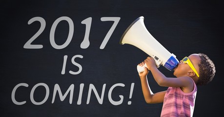 Boy with megaphone against 2017 new year sign