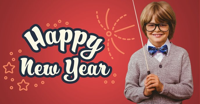 Smiling boy with stick standing against happy new year greeting 