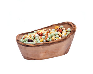 Natural crunchy dried veggies in olive wood bowl isolated on white background