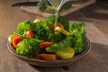 Pouring Melted Butter over Steamed Vegetables