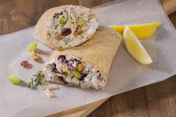 Chicken Wrap Cut in Half on Cutting Board with Wax Paper