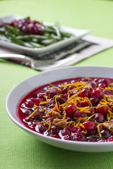 Bowl of Cranberry Sauce with Green Beans in the Background