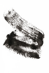 Stroke (sample) of black mascara on background