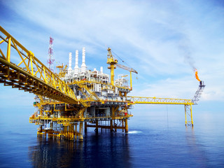 A supply ship being loaded and unloaded from on an offshore oil rig