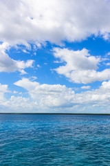Naklejka na ściany i meble open blue sea cumulus clouds