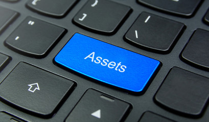 Business Concept: Close-up the Assets button on the keyboard and have Azure, Cyan, Blue, Sky color button isolate black keyboard