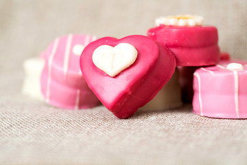 Small heart-shaped chocolates with white background, ideal for y