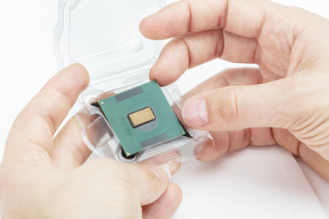 Hands of male take out the CPU out of the box. Isolated on white background.