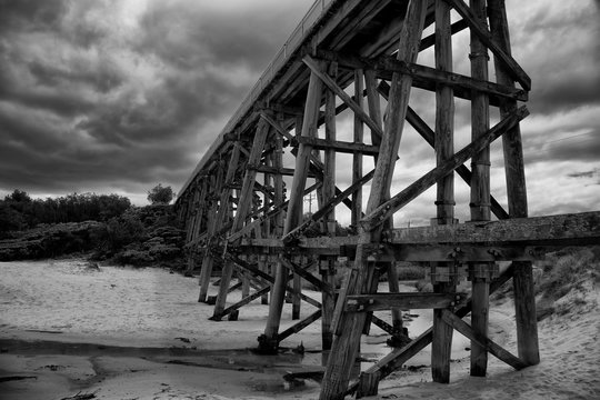 Fototapeta Trestle bridge in Kilcunda, Australia, 91 meter long built over the Bourne Creek.  Black and white.