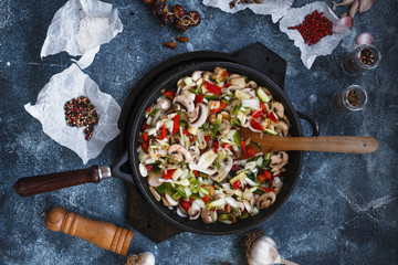 Mushrooms bell peppers stew in frying pan. Overhead of Vegetables stew cast iron pan. 