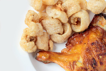 Streaky pork with crispy crackling and Grilled chicken leg ioslated on white background close-up. horizontal view from above. Thai Food