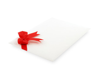 white envelope of invitation or greeting card decorate with simple red ribbon bow isolated on white