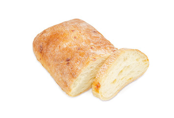 Partly sliced ciabatta on a light background