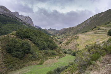 Fototapeta na wymiar Valley of the River Trabanco, La Peral, in Somiedo Nature Reserve. It is located in the central area of the Cantabrian Mountains in the Principality of Asturias in northern Spain