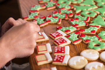 woman decorating gingerbread christmas cookies