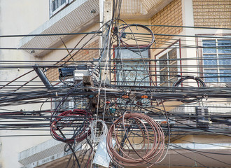 A close up Wire electric in pole it messy and chaotic