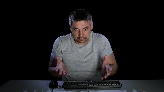 Man feels the emotions of perplexity communicating on the internet