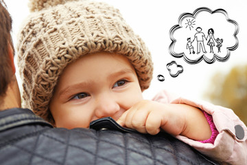 Cute little girl dreaming of happy family. Adoption, custody and childcare concept.