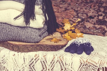 Knitting clothes on wooden background