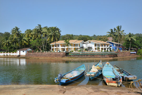 Fototapeta Fishing boats moored on the shore of Baga river in Goa