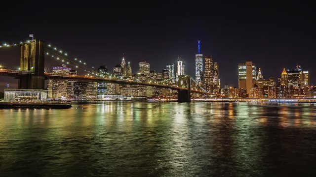 Night Manhattan and Brooklyn Bridge. The famous business district of New York. The flow of the river beautifully describes the following