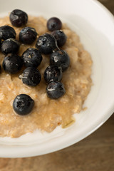 Breakfast Porridge, Blueberry Oatmeal on Wooden Background