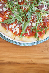 Tasty pizza with arugula on the top
