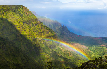 Look down from Pihea trail into Kalalau valley with double rainbow, Kauai, Hawaii. Shoot through a...