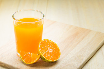 Oranges isolated cut set on wooden base , glass