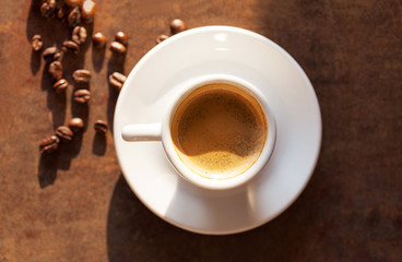 White cup of espresso coffee on background