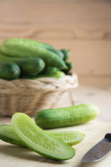 Fresh cucumber and slices on wooden table..