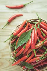 basket full of red chili peppers on wood.. , vintage