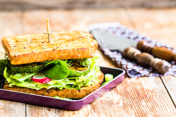 Vegan sandwich with fresh vegetables and grilled zucchini