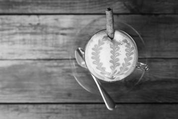 A cup of cafe latte on wood.