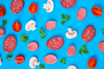 Mushrooms, tomatoes and sausage on a blue background. food concept, stylized photo