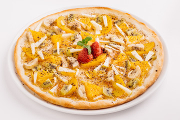 Sweet pizza with fruits on table