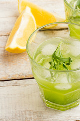 Green lemonade with tarragon and ice closeup