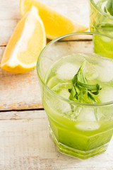 Green lemonade with tarragon and lemon in a glass