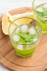 cocktail with tarragon on a wooden board