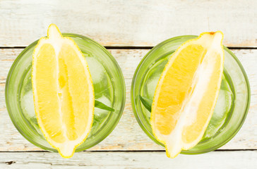 drink with tarragon and lemon on a wooden background