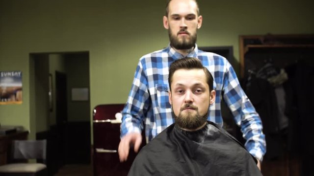 A male client having his mustache and beard groomed at a barbershop