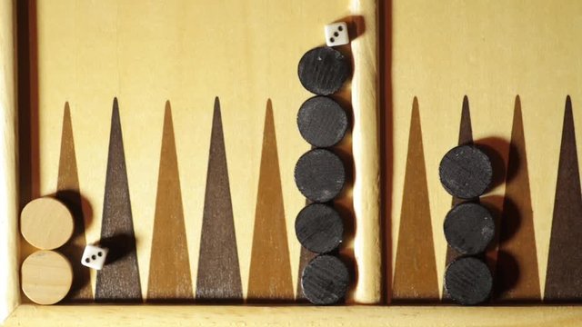Still shot of a backgammon board with some rolling dice.