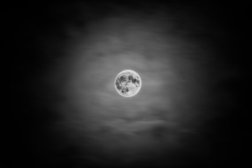 Full moon thorugh clouds black white