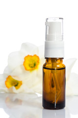 Face cream bottle with flowers isolated on white