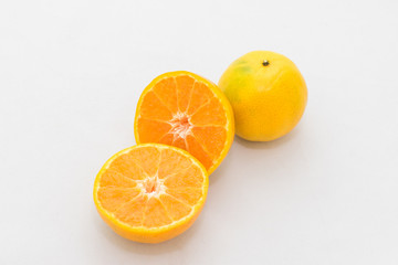 whole and half cut orange on white background