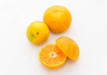 whole and half cut orange on white background
